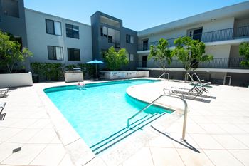 a swimming pool in front of an apartment building
